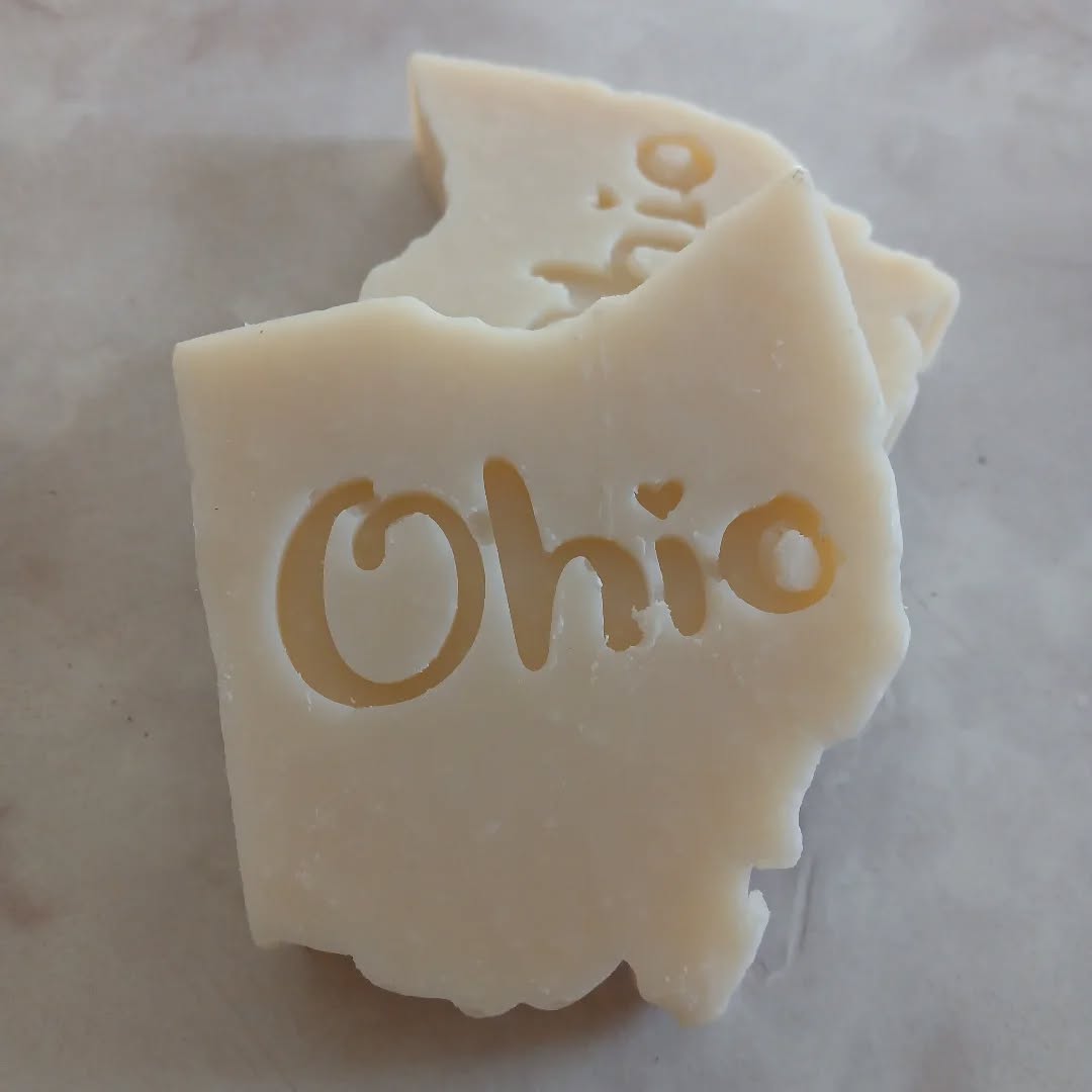 Soap in the shape of Ohio with the word OHIO on, it in a creamy white color