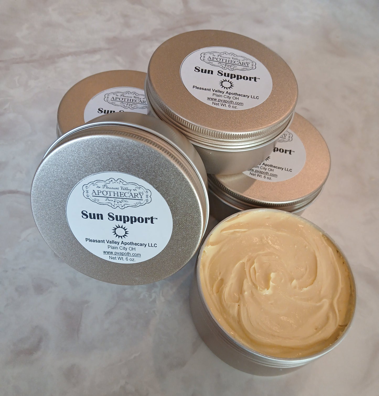Gold tin with creamy sun lotion inside