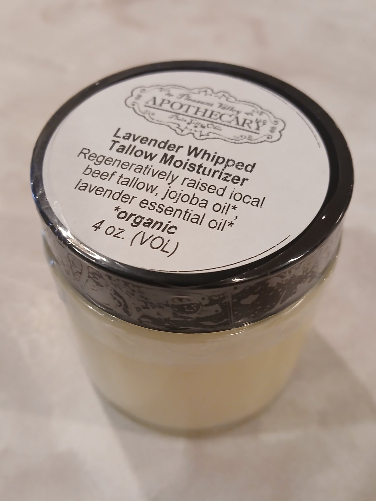 4 ounce jar of whipped tallow that is scented with lavender essential oil