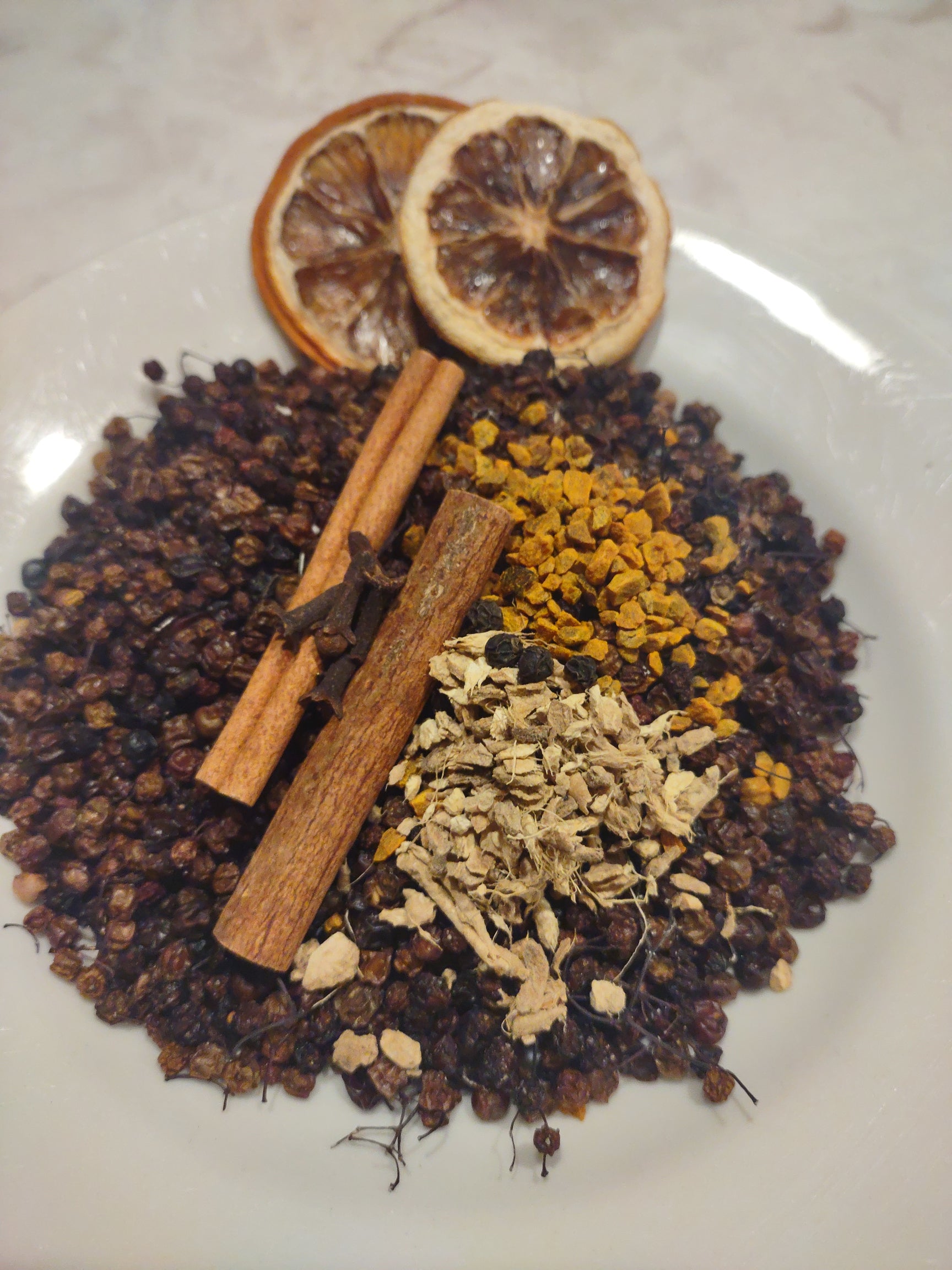 Pleasant Valley Apothecary's elderberry syrup kit - ingredients in a bowl with optional lemon slices 