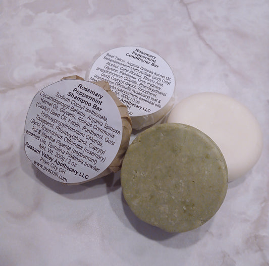 a picture of shampoo and conditioner bars , 1 set is wrapped and labeled, one set is unwrapped. shampoo bar is green and conditioner bar is white