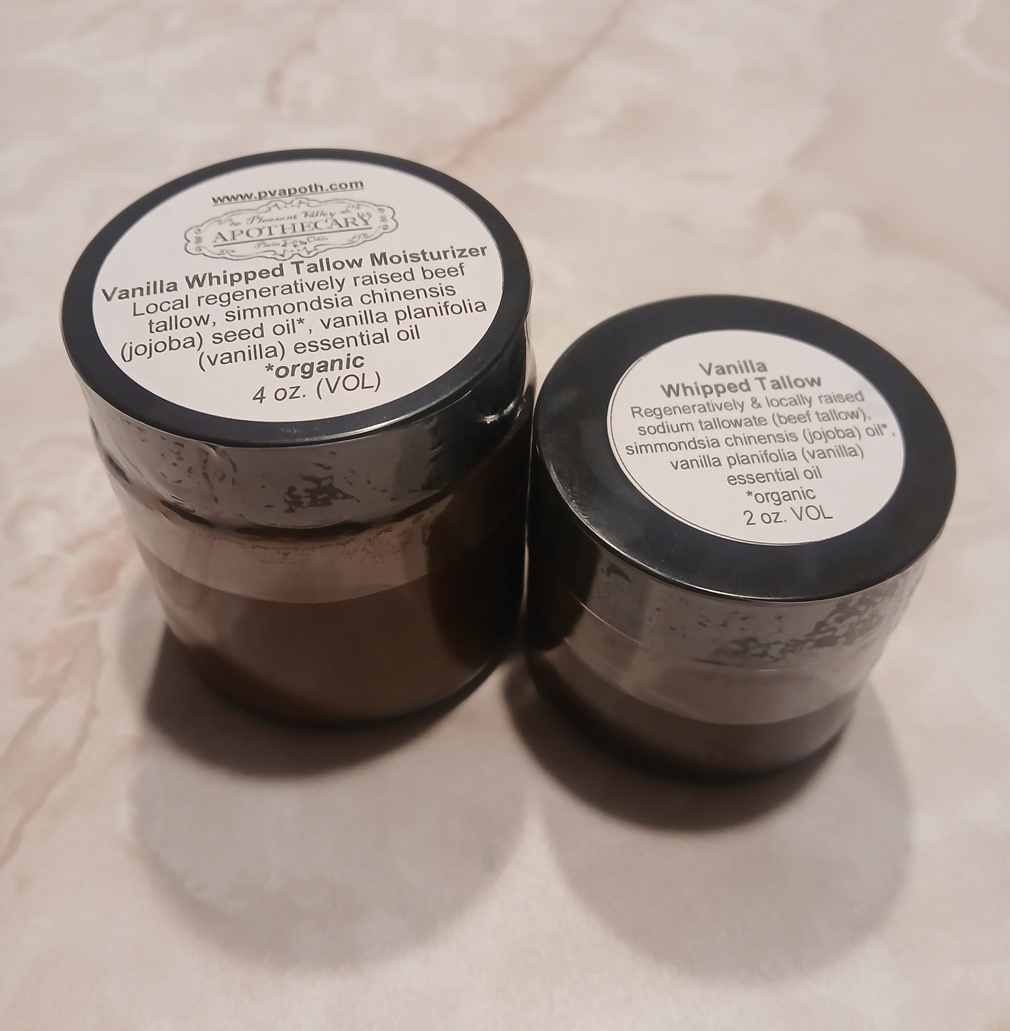 whipped tallow moisturizer in 4ounce and 2 ounce amber glass jars with black lids