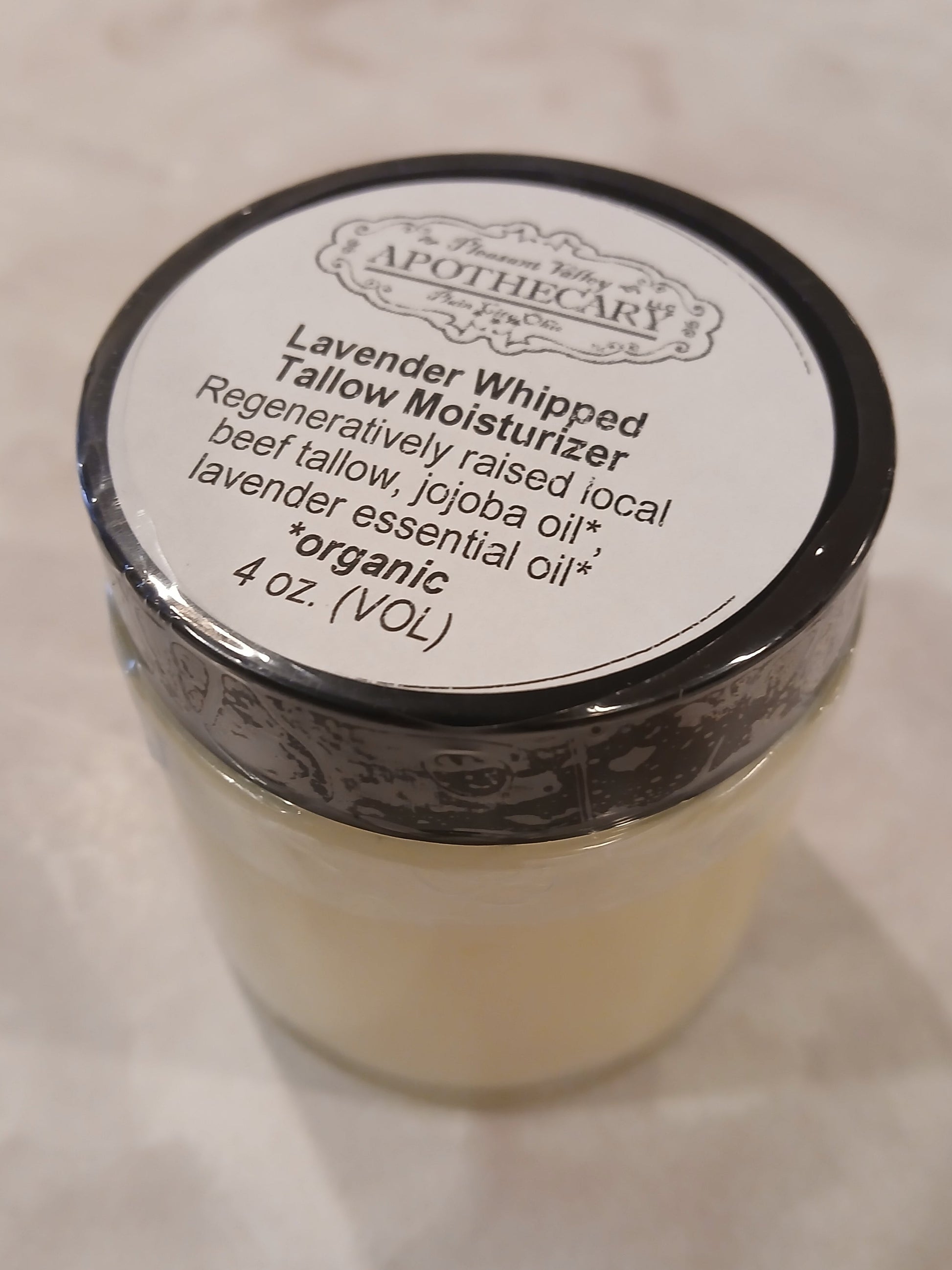 4 ounce jar of whipped tallow that is scented with lavender essential oil